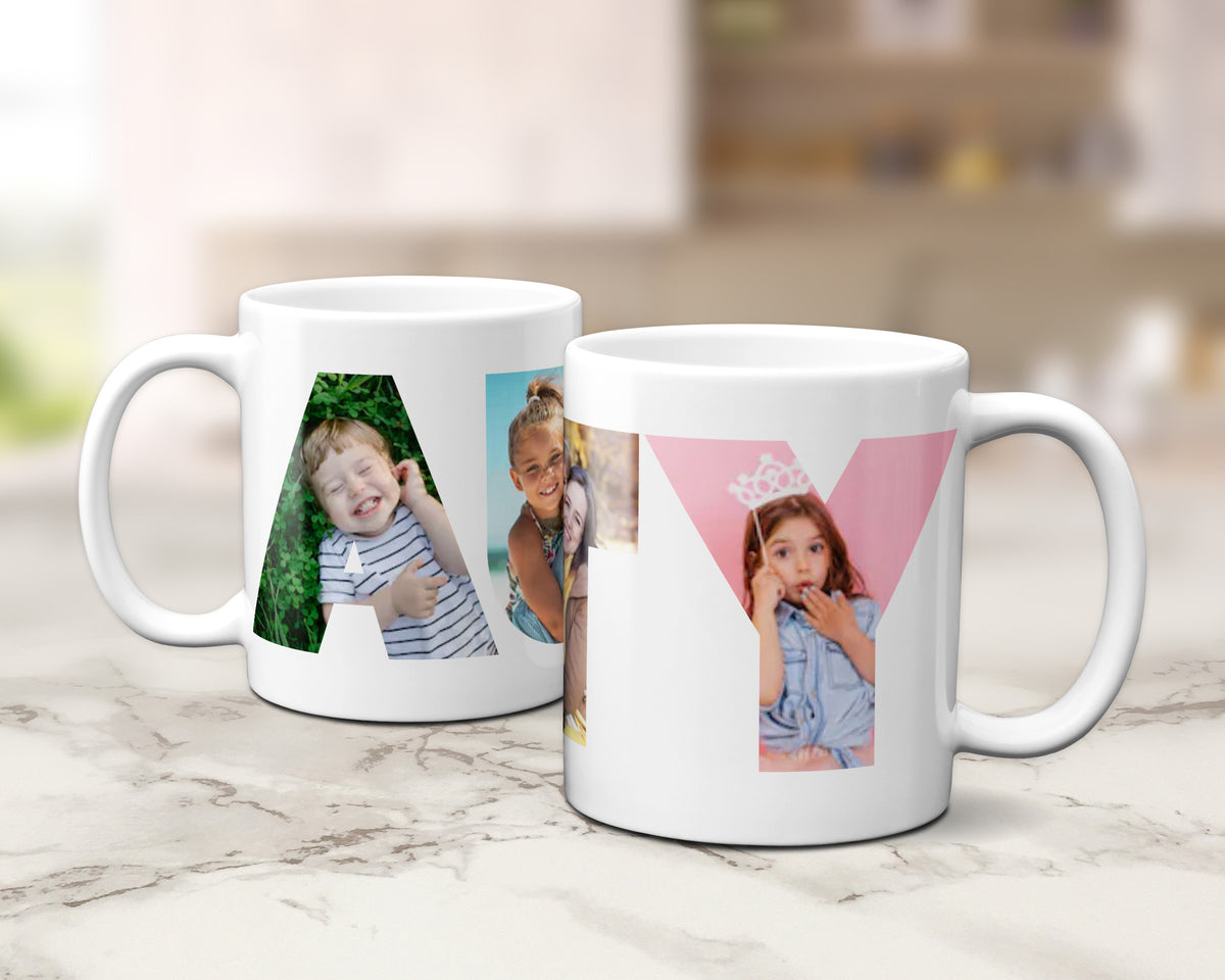 Two white ceramic mugs with custom photo filled letters 'AUNTY' designs, displayed on a light marble countertop with a blurred kitchen background.