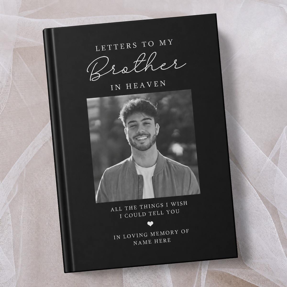 Personalised black hardcover memorial journal titled ‘Letters to My Brother in Heaven’, featuring a black and white photo of a smiling man on the cover with the words ‘All the things I wish I could tell you’ and ‘In loving memory’, personalised with a name