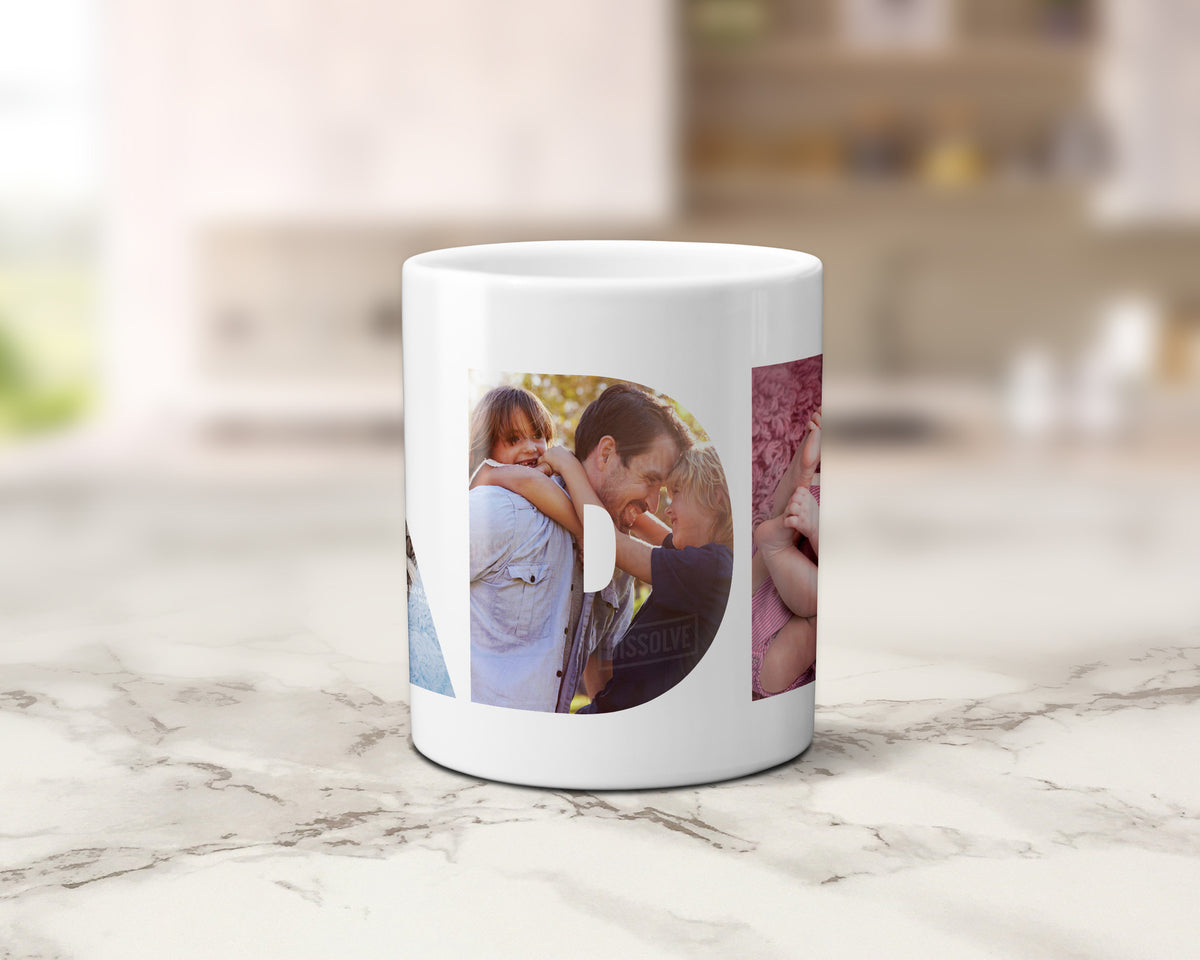A white ceramic coffee mug with custom printed circular and rectangular family photos, displayed on a light marble countertop with a blurred kitchen background.