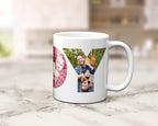 A white ceramic coffee mug with a custom photo collage printed on the side, displayed on a light marble countertop with a blurred kitchen background.