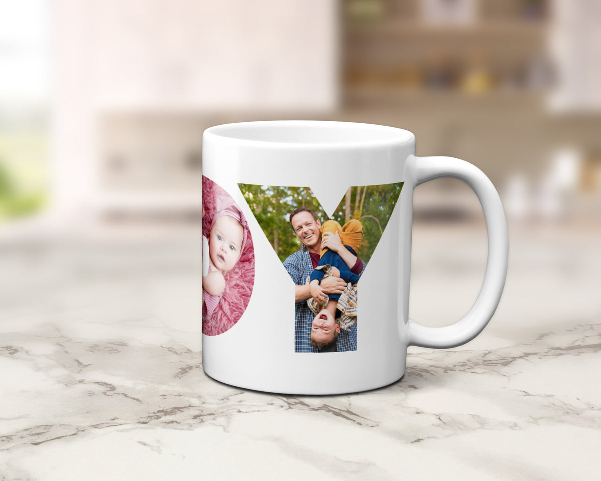 A white ceramic coffee mug with a custom photo collage printed on the side, displayed on a light marble countertop with a blurred kitchen background.