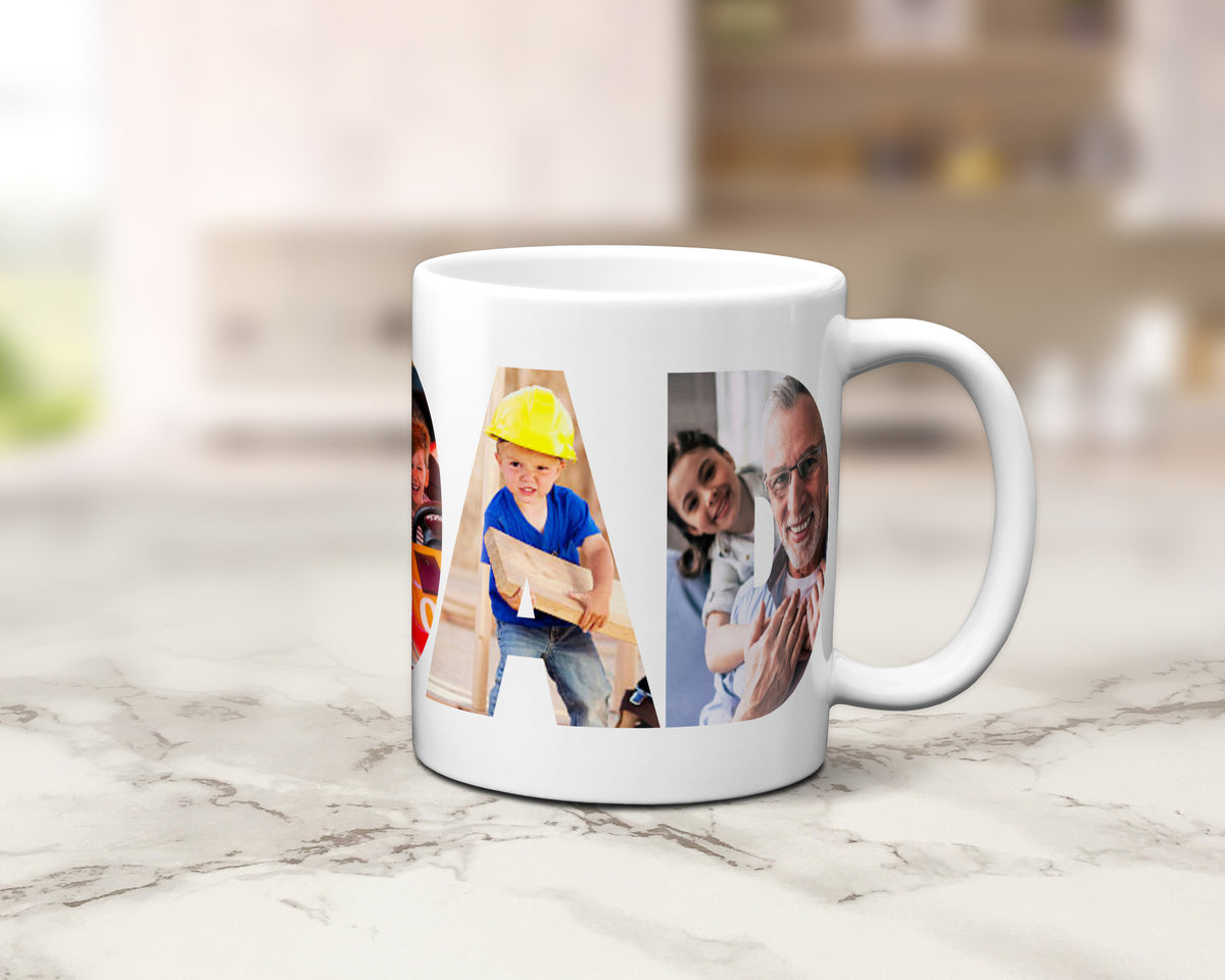 A white ceramic coffee mug with a custom photo collage within the letters spelling 'GRANDAD', set on a light marble countertop with a blurred kitchen background.