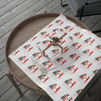 Gift box with a bow on a table covered with patterned paper