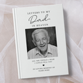 A hardcover book titled 'Letters to My Dad in Heaven' with a black and white portrait photo of an elderly man on the cover, styled on a white background with sheer white tulle.