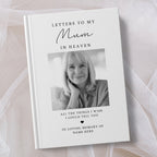 A personalised hardcover book titled 'Letters to My Mum in Heaven' with a black and white portrait photo of a woman on the cover, styled on a soft white fabric background.