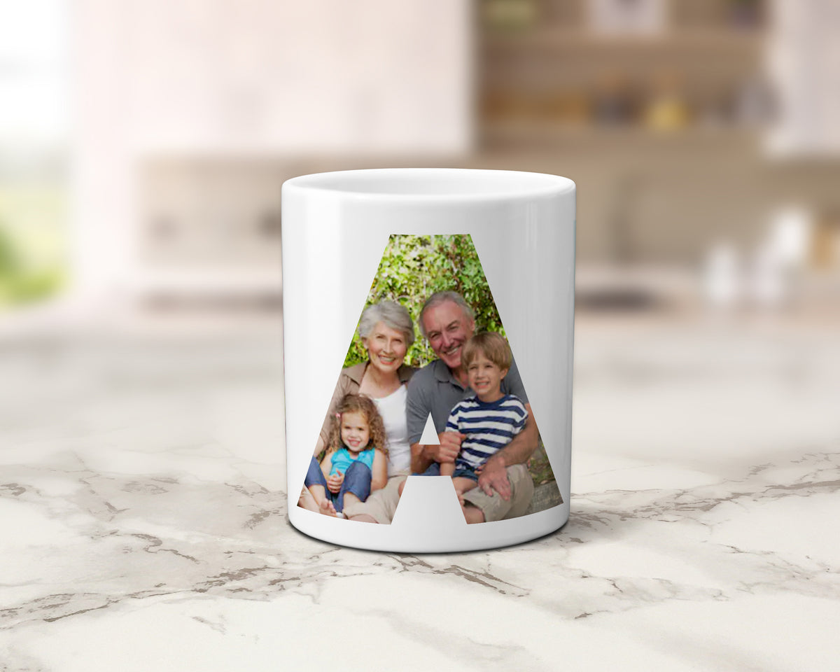 A ceramic mug with family photos within the letters spelling NAN.