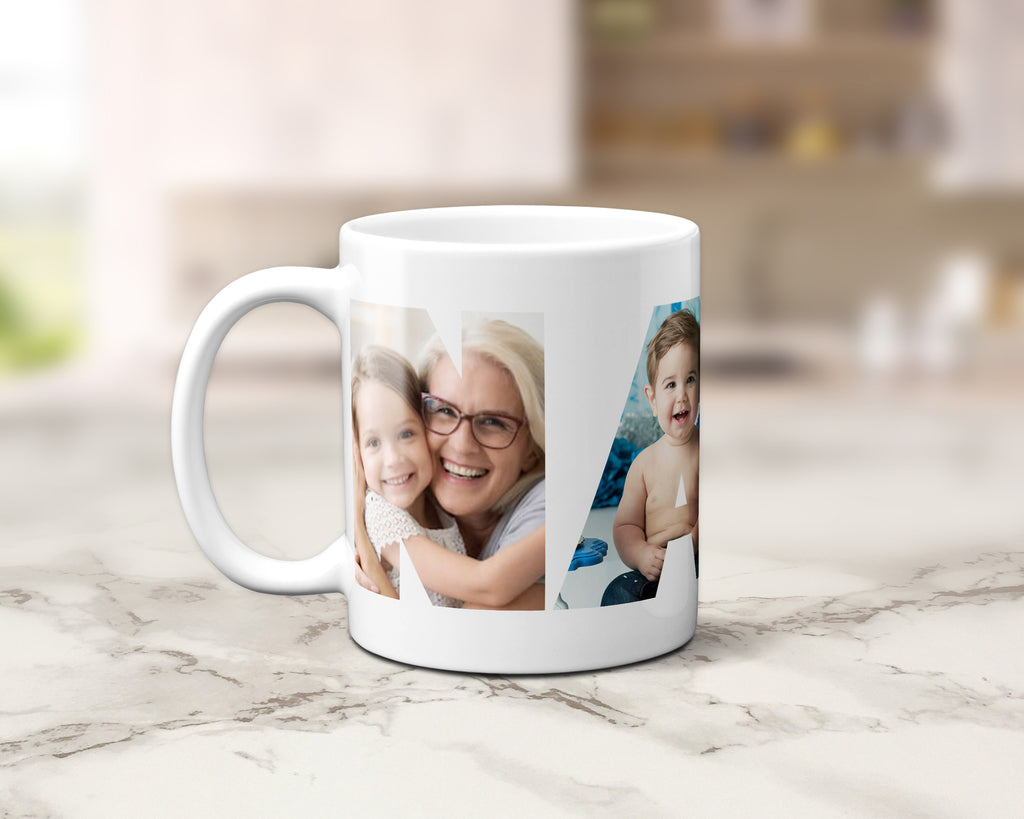 A white ceramic coffee mug with custom printed family photos within the letters spelling NANNA, displayed on a light marble countertop with a blurred kitchen background.