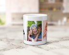 A white ceramic mug featuring a custom multi photo collage within the letters spelling NANNA, set on a light marble countertop with a blurred kitchen background.