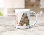 A white ceramic coffee mug with a custom photo collage within the letters spelling NANNA, displayed on a light marble countertop with a blurred kitchen background.