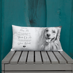 A rectangular personalised pet memorial throw pillow with a black and white photo of a golden retriever and sentimental text, displayed on a grey wooden bench against a teal wooden wall.