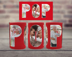 Three red can coolers with a matching red rectangular backdrop, each with large letters spelling 'POP', displaying family photos inside. The coolers are arranged on a grey wooden surface with a blurred brick wall background.