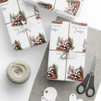 Three Christmas themed gift wraps wrapped around rectangular boxes, styled with twine, a heart-shaped tag, a ball of jute twine, scissors, and white round tags on a light grey surface.