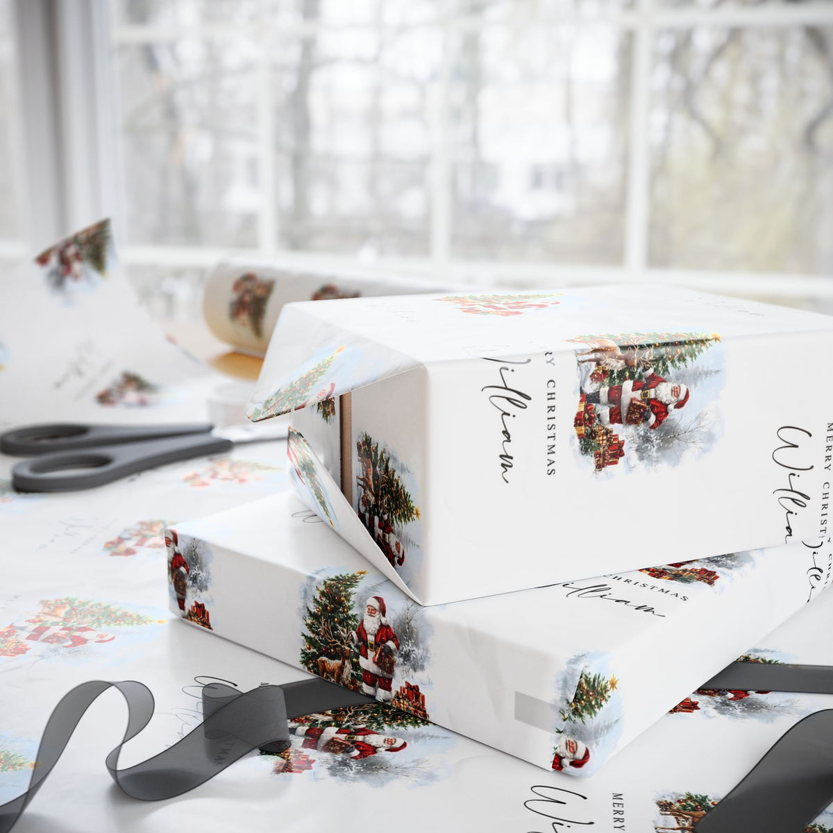 White Christmas-themed gift wrapping paper and matching gift boxes with illustrations of Santa Claus, a Christmas tree, and snow, styled on a table with scissors and ribbon in front of a bright window.