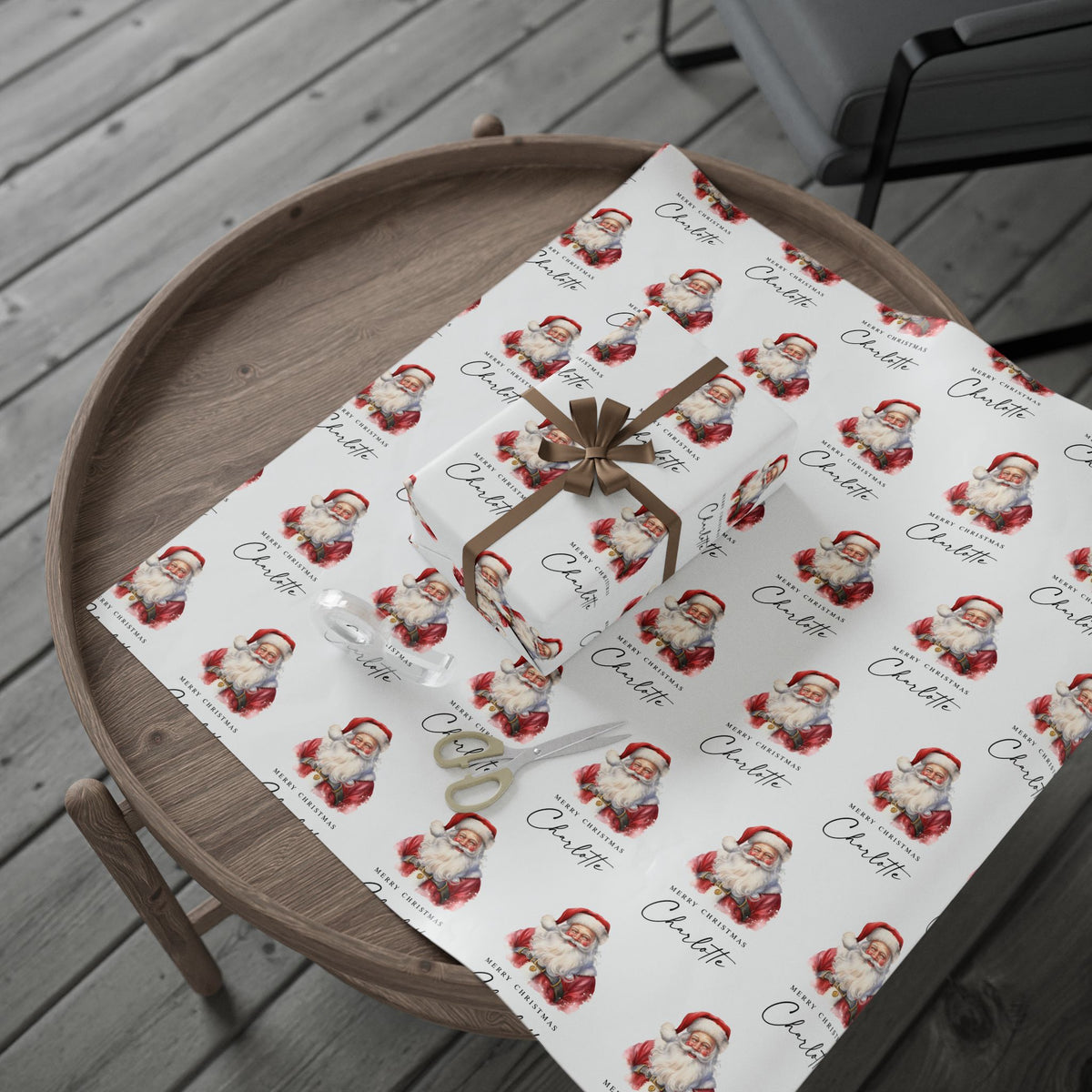 Personalised Christmas wrapping paper featuring classic watercolour Santa Claus design, displayed unrolled with a wrapped gift on a wooden tray